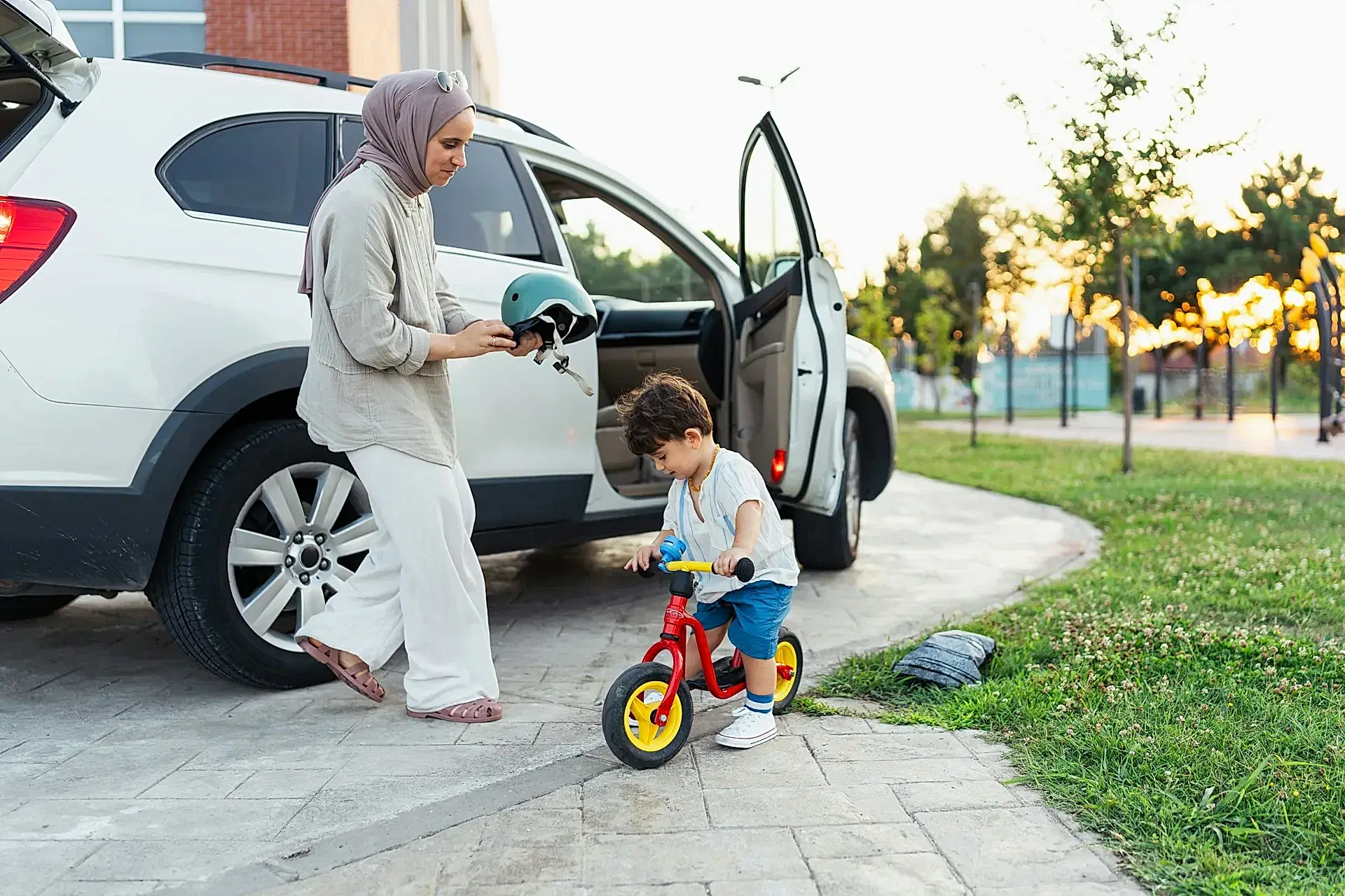 A woman and a kid on a bike