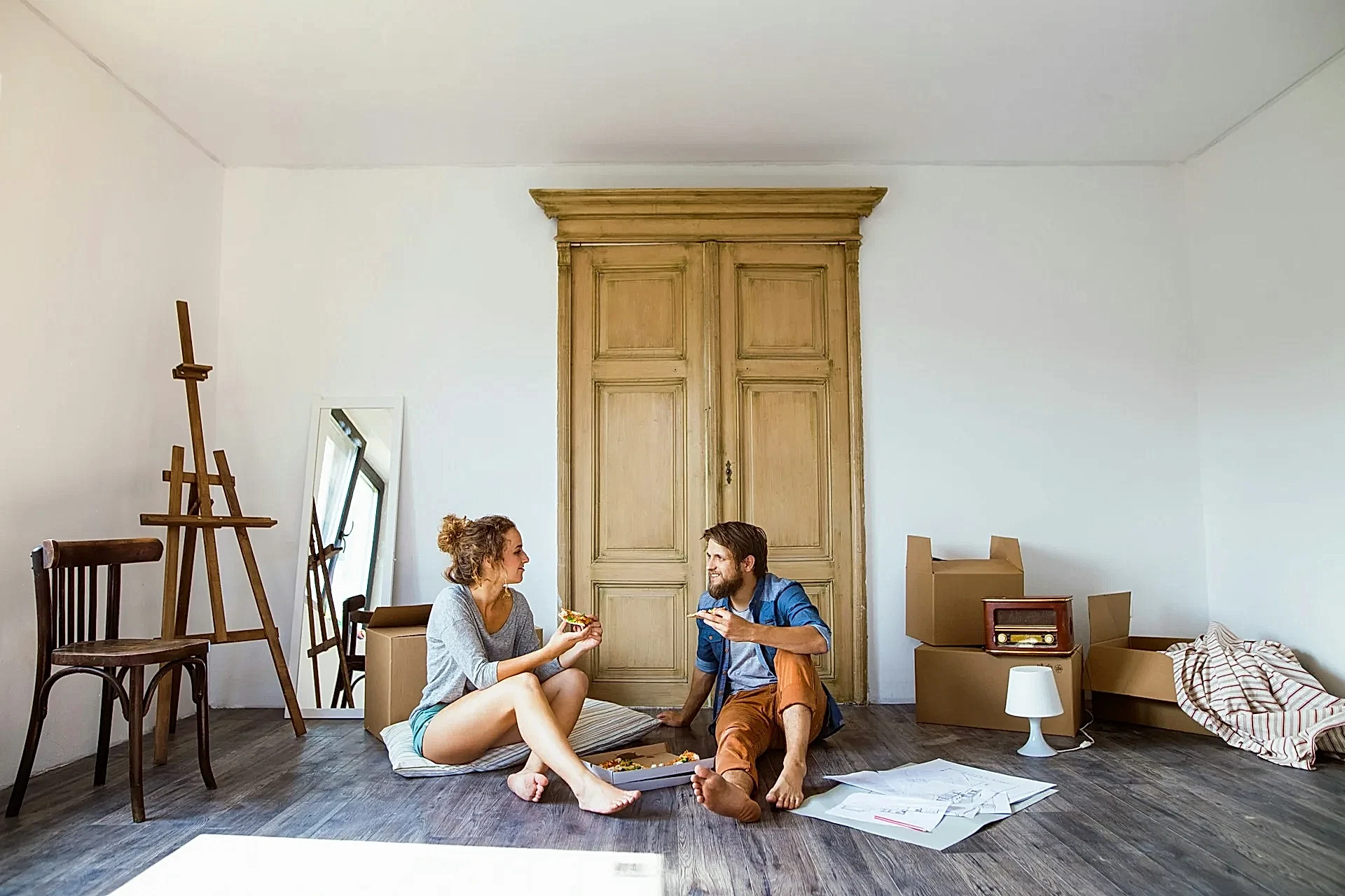 A couple sitting on a floor