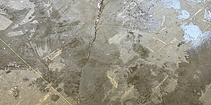commercial-crackedslabwarehouse Cracked concrete slab in a commercial warehouse.