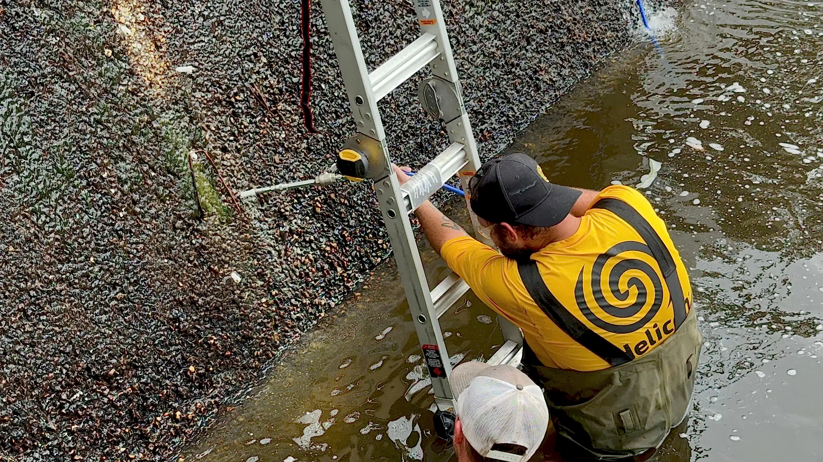 Polyurethane grout injection into eroded subsurface soil beneath spillway using specialized equipment to prevent further water intrusion.