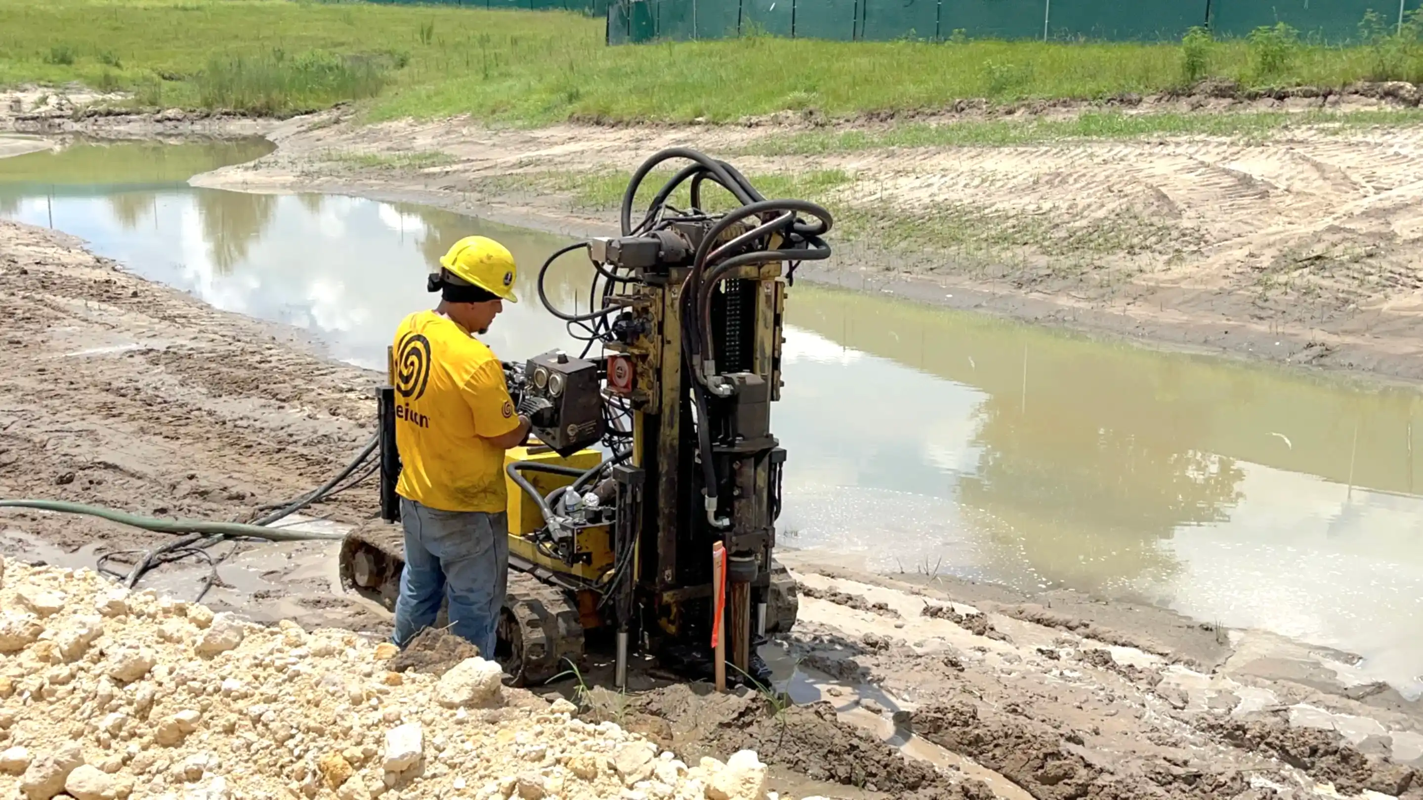commercial-drilling Helicon crew member drilling on compaction grout site.