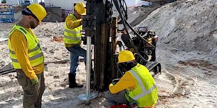 commercial-preconstruction-helical Pre-construction helical piers being installed.
