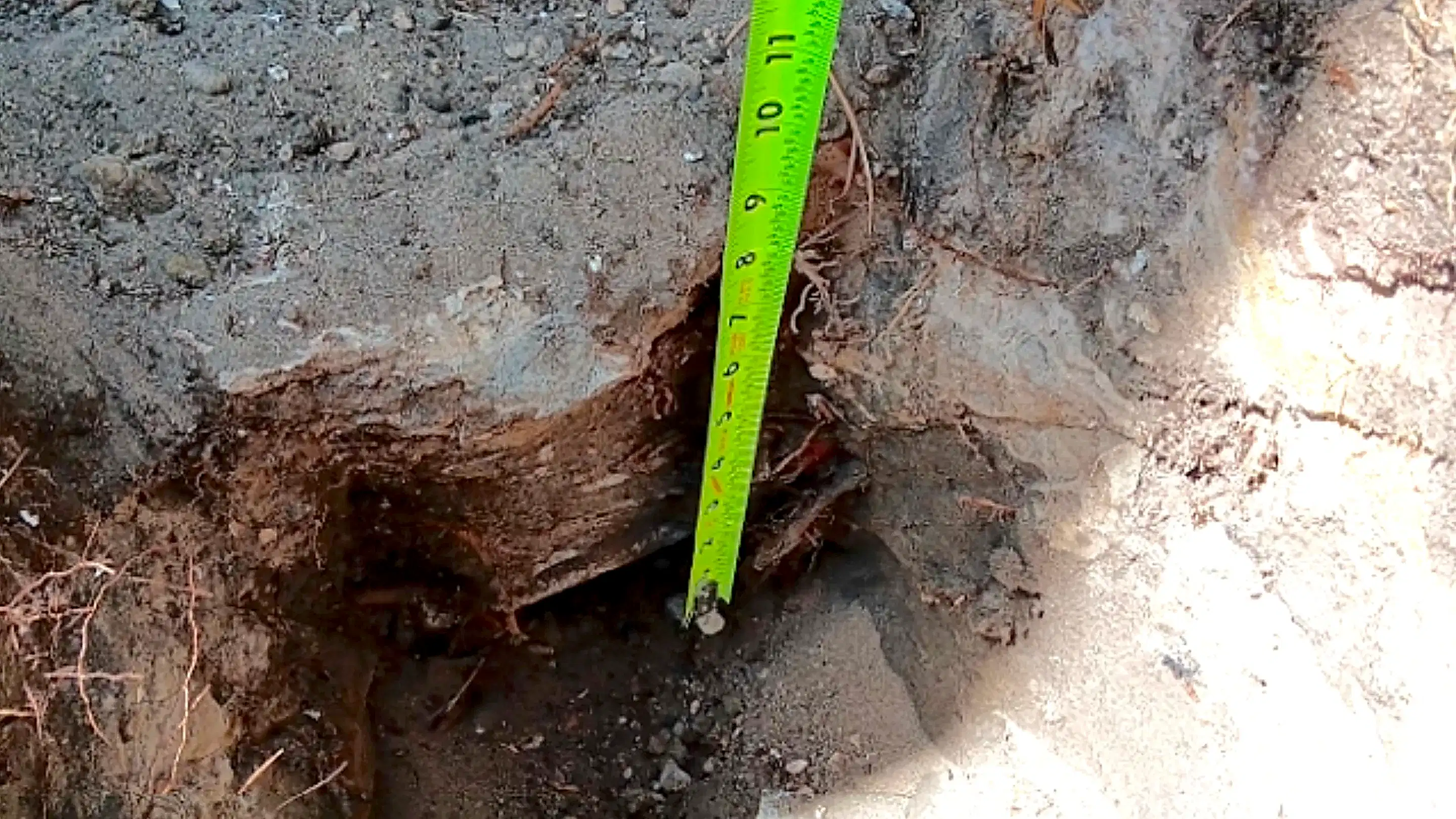 Foundation repair excavation showing footing depth and soil conditions in Florida sandy soils.